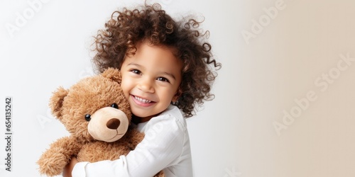 child hugs a bear doll on a white background, generative AI
