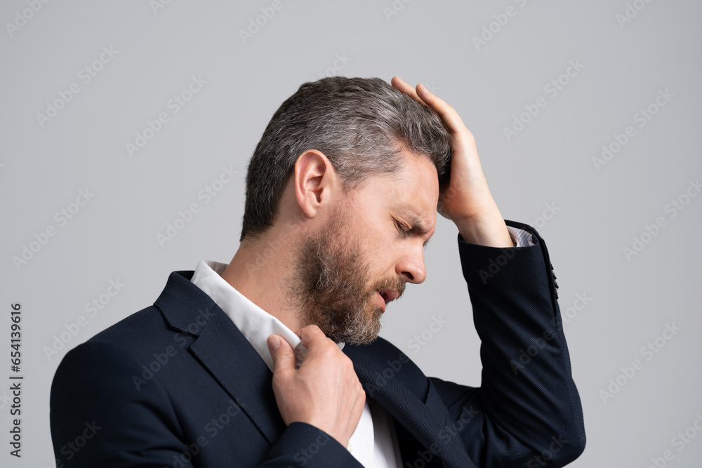 Tired exhausted man suffering from headache. Business problems. Head pain migraine. Business man in suit with migraine. Business man got migraine touches head because of pain. frustration Tired exhausted man suffering from headache. Business problems. Head pain migraine. Business man in suit with migraine. Business man got migraine touches head because of pain. frustration