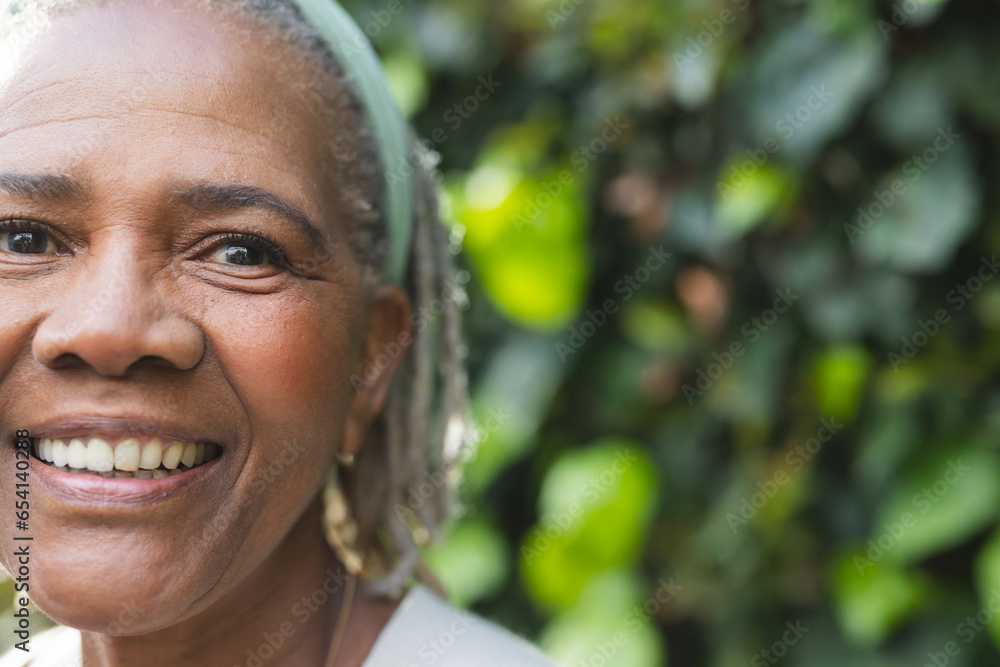 Portrait of happy senior african american woman standing in garden, copy space Portrait of happy senior african american woman standing in garden, copy space