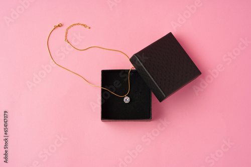 Small jewelry box on pink studio background