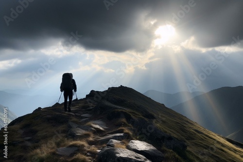 a mountain with a sun shining through the clouds and a person standing on a hill with a backpack, under a dark sky with climate changes. Generative AI © Clio