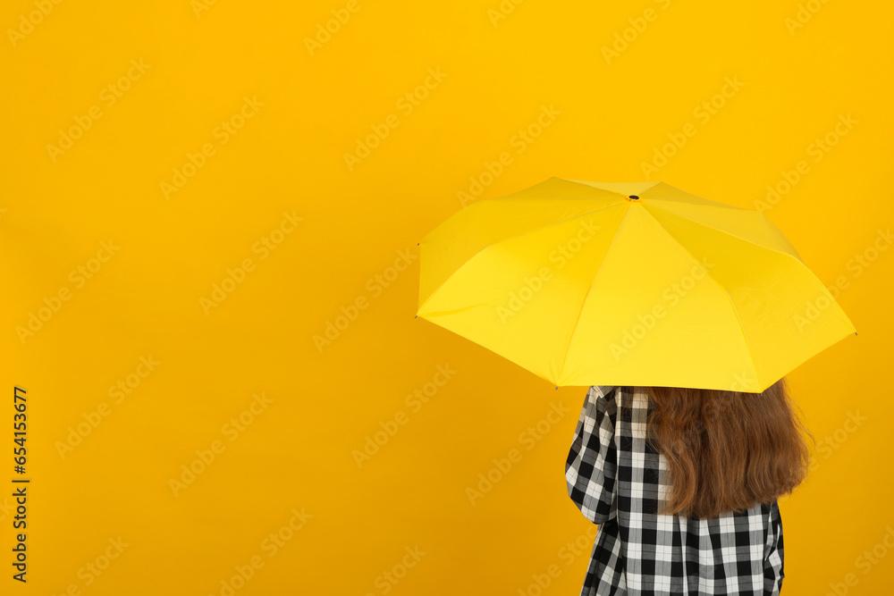 An umbrella in the hands of a person.