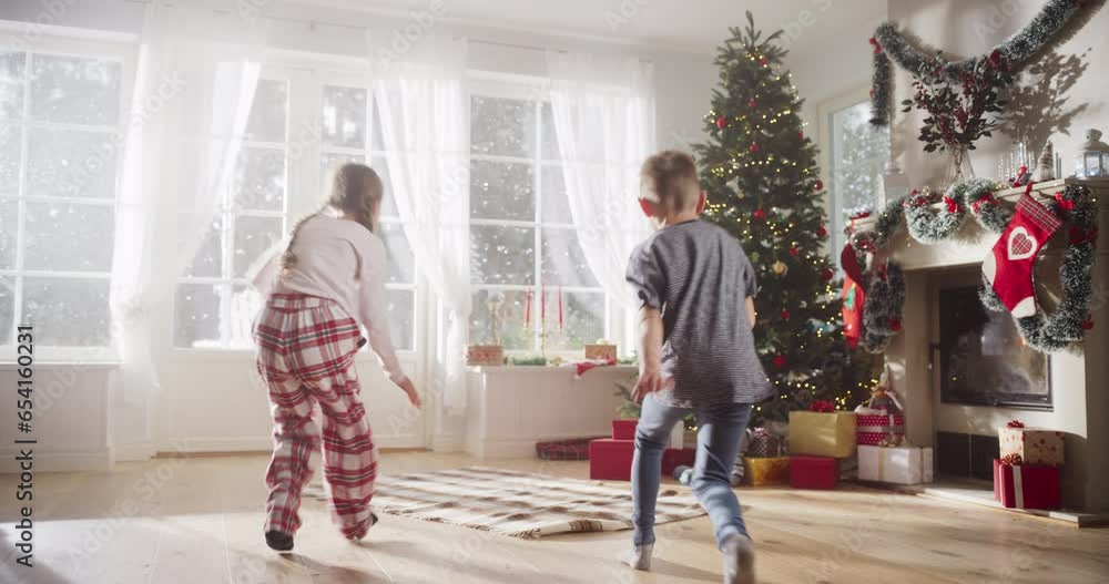 Slow Motion of Cute Kids in Pajamas Running To Get Their Gifts On Christmas Bright Morning. Happy Kids Getting Surprised While Opening Holiday Wrapped Gift Boxes, Receiving New Toys from Santa Slow Motion of Cute Kids in Pajamas Running To Get Their Gifts On Christmas Bright Morning. Happy Kids Getting Surprised While Opening Holiday Wrapped Gift Boxes, Receiving New Toys from Santa