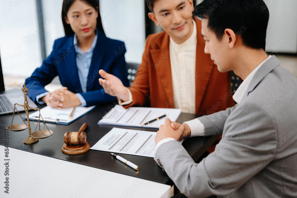 Fototapeta premium Business people compassionately holding hands and discussing contract papers with laptop and tabletat office room..