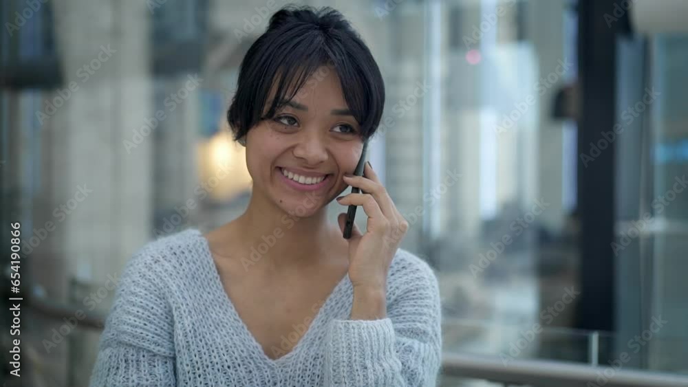 Portrait shot of happy smiling asian young woman chatting on the phone, walking alongside the open space common area of business center. Close up of asian girl having a call Portrait shot of happy smiling asian young woman chatting on the phone, walking alongside the open space common area of business center. Close up of asian girl having a call