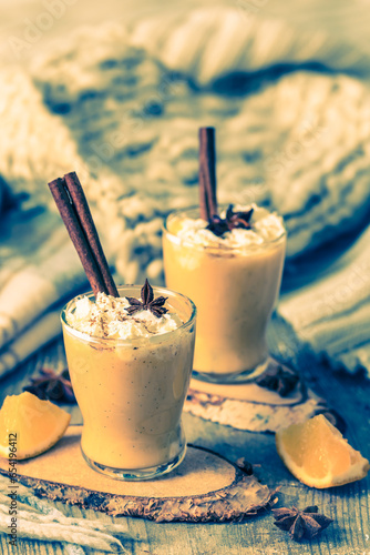 Two glasses of eggnogg with whipped cream and cinnamon photo