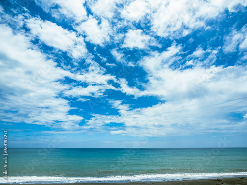 The Seashore and the Blue Sky with White Clouds