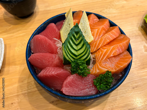 sashimi of tuna and salmon in black bowl