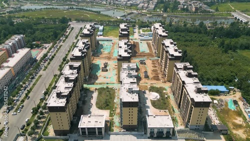 Aerial over construction site with apartments, ever-evolving urban landscape in Huayin, a city nestled in the heart of Shaanxi Province, China. City's rapid development and growth concept. UHD. photo