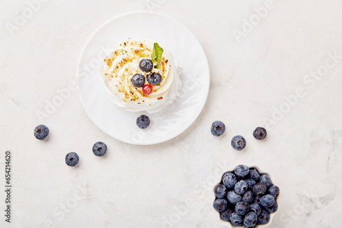 Top view of Pavlova Dessert with blueberry. Autumn aesthetics vibes background. Cozy home table setting
