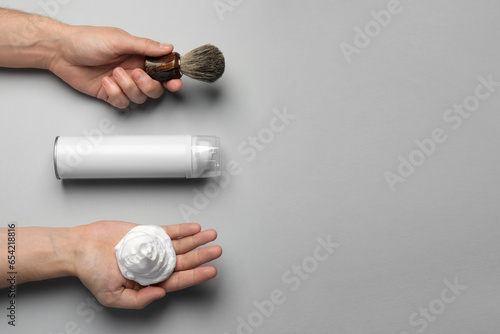 Fotografie, Obraz Man with shaving foam, brush and bottle on light grey background, top view