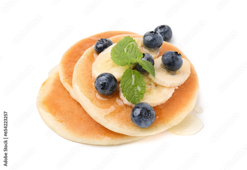 Delicious pancakes with banana slices, blueberries and mint isolated on white Delicious pancakes with banana slices, blueberries and mint isolated on white