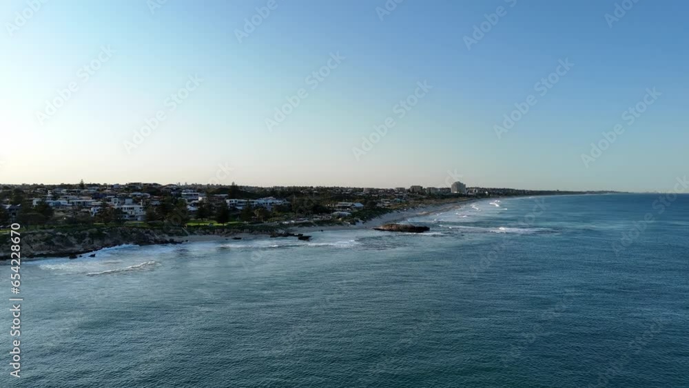 Sunrise along the Western Australian coast with Perth city skyline in the background on clear sky day Sunrise along the Western Australian coast with Perth city skyline in the background on clear sky day