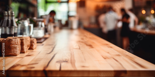 Top of wooden table on blur background with lights of bar  cafe  coffee shop or restaurant and barista . Using for mock up template for display of your design