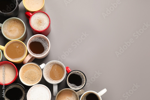 Many different cups with aromatic coffee on grey table, flat lay. Space for text