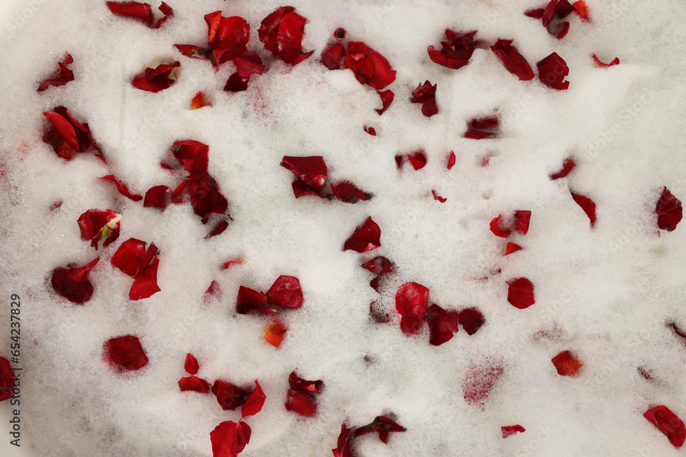 Foam and red rose petals as background, top view. Relaxing bath Foam and red rose petals as background, top view. Relaxing bath