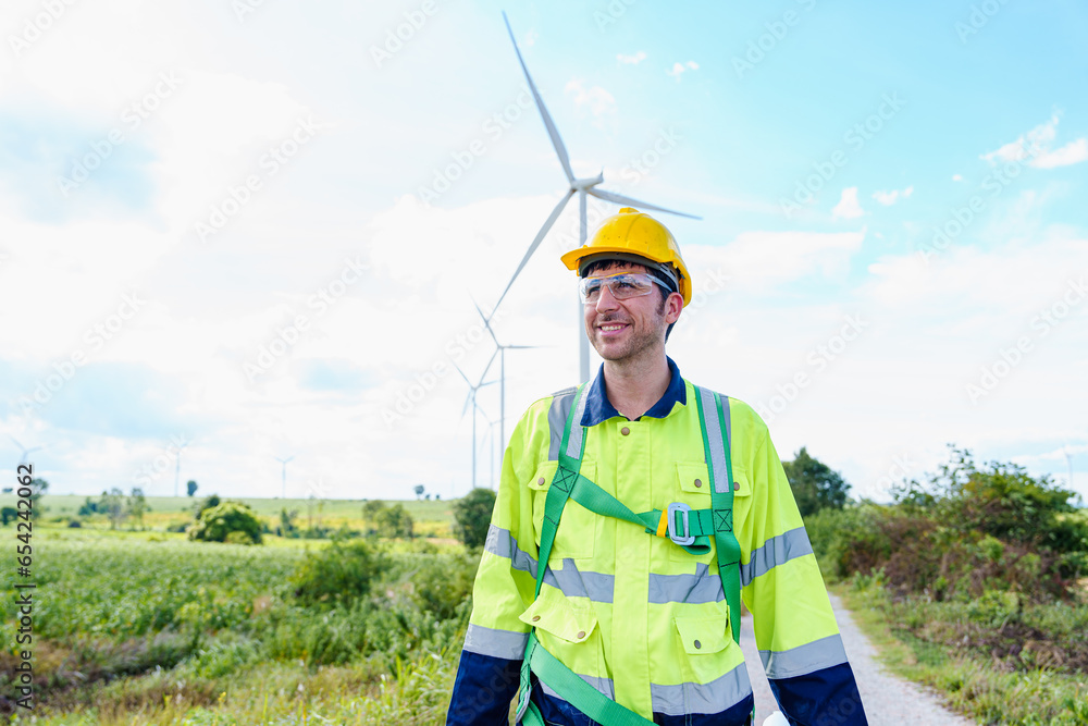 Technician engineer caucasian Man working and maintenance with wind turbine blueprint drawing of wind turbines at windmill field farm. Alternative renewable energy for clean energy concept. Technician engineer caucasian Man working and maintenance with wind turbine blueprint drawing of wind turbines at windmill field farm. Alternative renewable energy for clean energy concept.