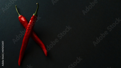 Red hot natural chili pepper on a dark background. Chili tenderloin path. Organic fresh chili pepper isolated on black.