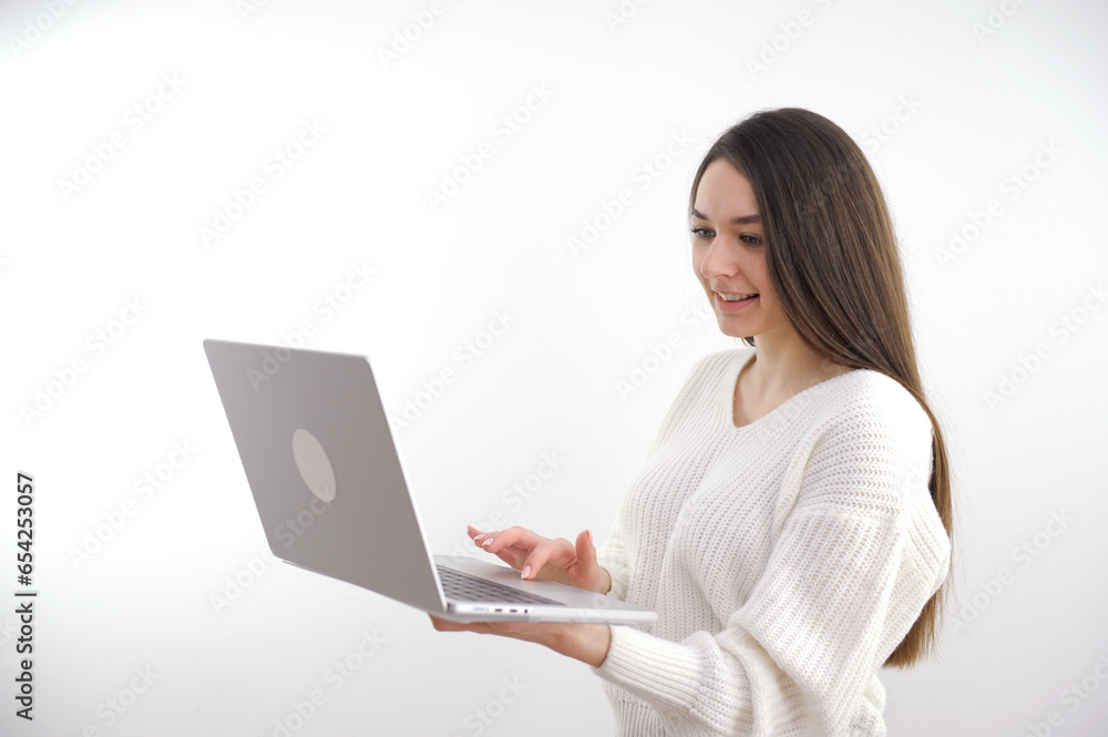 Pointing laptop screen, portrait of caucasian 20s woman pointing laptop screen. Woman holding modern laptop with empty blank screen mockup for website. Smiling happy girl. Isolated white background. Pointing laptop screen, portrait of caucasian 20s woman pointing laptop screen. Woman holding modern laptop with empty blank screen mockup for website. Smiling happy girl. Isolated white background.