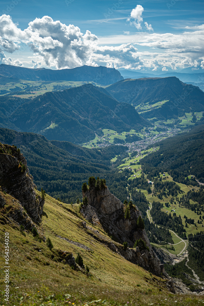 Fototapeta premium The side landscape view with a wide-angle lens from the top of Seceda mountain in Dolomites, Italy , sunset time