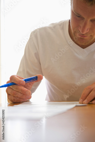 Close up of a man signing documents
