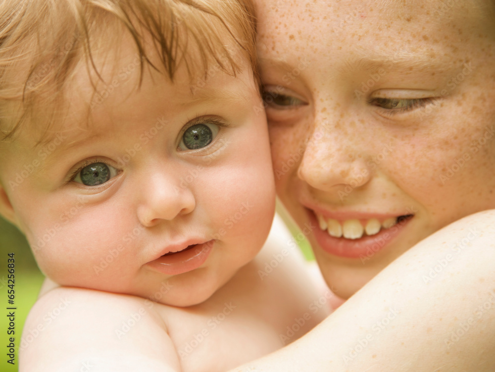 Close up of a young boy holding his baby brother
Close up of a young boy holding his baby brother