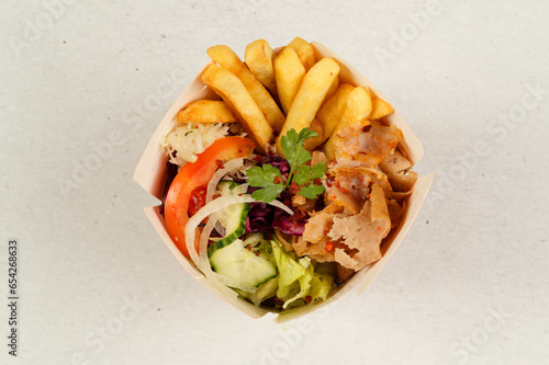 Turkish Kebab box with french fries isolated on white background.