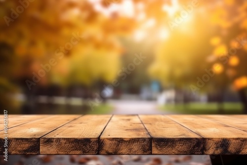 Wooden tabletop on a blurred autumn background.