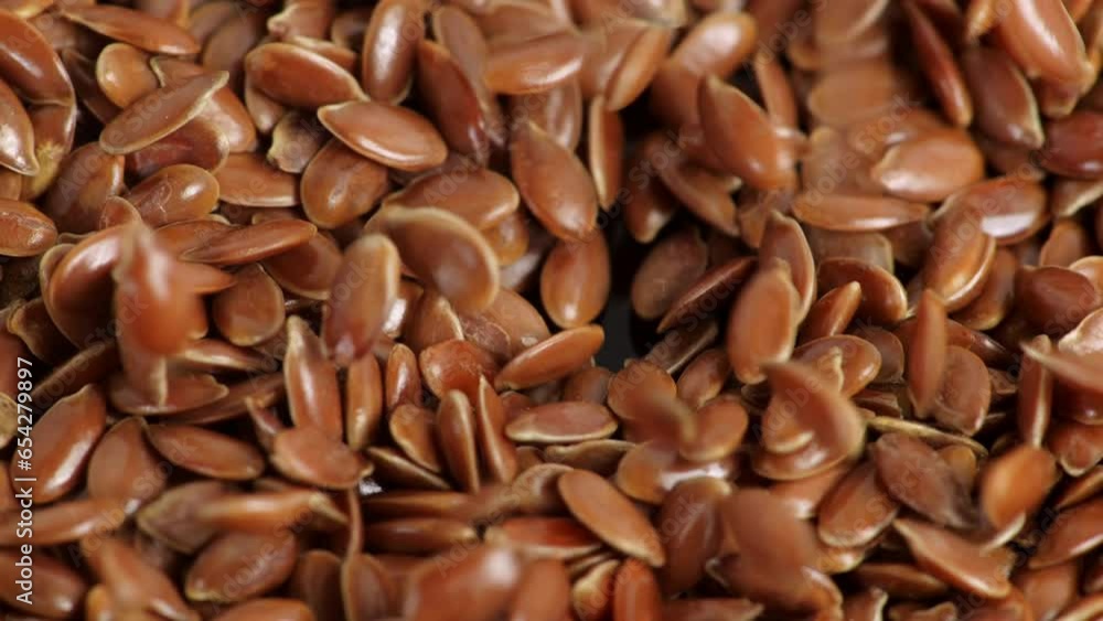 Flax seeds pouring end rotating in slow motion.
Flax seeds pouring end rotating in slow motion.