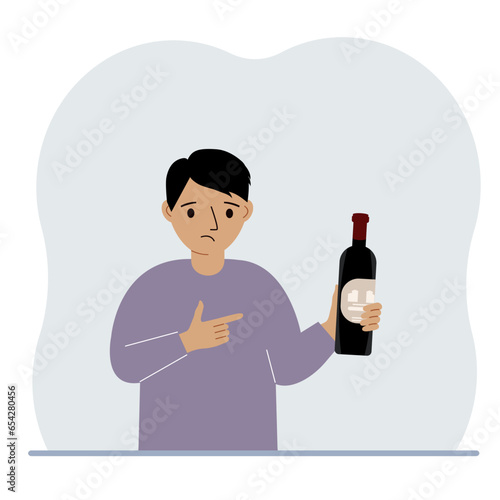 A little boy holds a bottle of wine in her hand. The concept of alcohol abuse, alcohol addiction by minors.