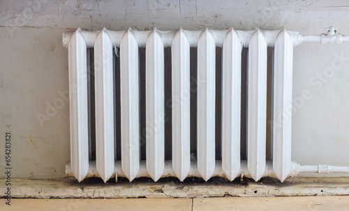 Vintage white cast-iron heating radiator, a charming relic of the past.