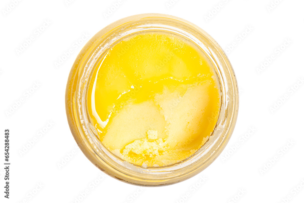 Ghee clarified butter in glass jar top view isolated on white background. Ghee clarified butter in glass jar top view isolated on white background.