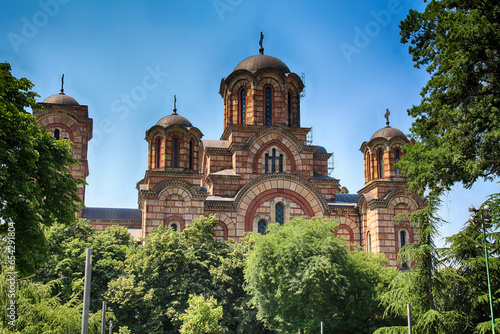 St. Mark's Church exterior view with green trees in sunny bright summer day