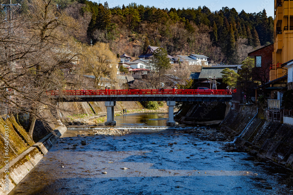 Historic Red Nakabashi Bridge in the old town of Takayama in spring, Miyagawa River Gifu Japan