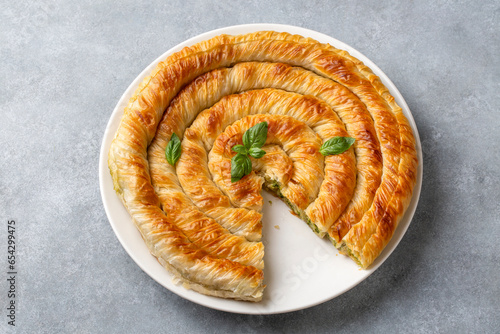 Spanakopita, greek phyllo pastry pie with spinach and feta cheese filling. Delicious handmade pies. Turkish name; el acmasi borek, rulo borek photo