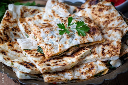 Turkish pancake gozleme with cheese and herb. The appetizer is Turkish pastry. There are varieties such as cheese, spinach, potato