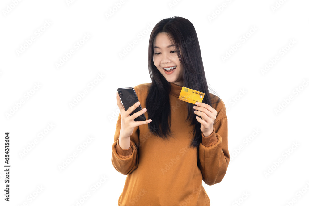 Asian woman holding credit card and looking at smartphone app, buying, order delivery in mobile phone application, standing isolated on white background with clipping path. Online shopping concept. Asian woman holding credit card and looking at smartphone app, buying, order delivery in mobile phone application, standing isolated on white background with clipping path. Online shopping concept.