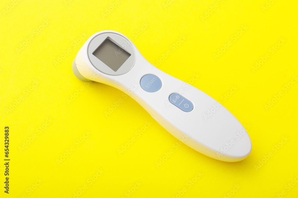 Electronic thermometer on a yellow background Electronic thermometer on a yellow background