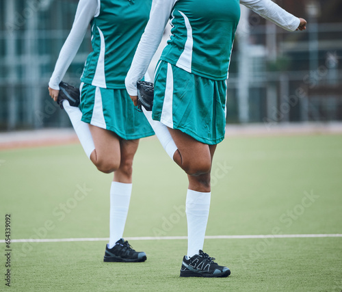Team, stretching legs and exercise on field, sports and uniform for match, balance and teamwork together. Training with athletes, outdoor and fitness to prepare for game, workout for performance