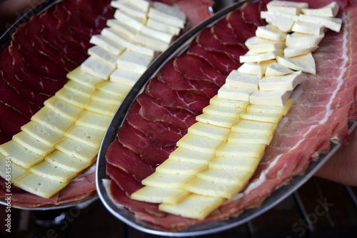 Montenegrin traditional food, Prshut and cheese on a metal tray photo