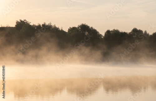 Landscape with steam evaporating from the water of a river in the morning