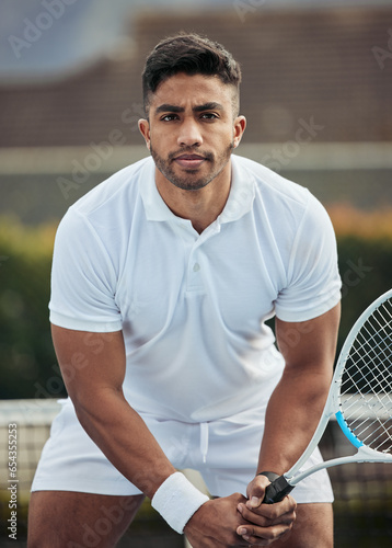 Outdoor, athlete and portrait of man in tennis, competition or game on court with training, exercise or workout. Sports, player or person with serious fitness mindset in healthy match or tournament © Siphosethu/peopleimages.com