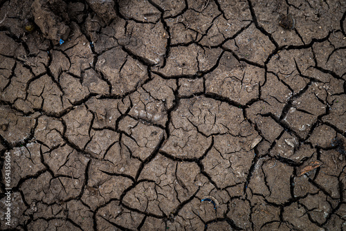 Top view of cracking ground the background or graphic design with the concept of global warming and drought. photo