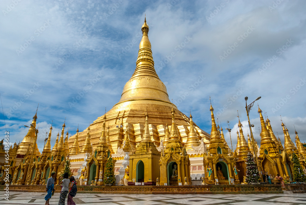 Naklejka premium Burmese people walk around the Shwedagon Pagoda a golden Pagoda in Yangon, Rangoon, Myanmar, Asia, 8th of July 2009