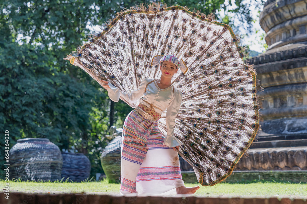 Beautiful Myanmar girl dancing performs imitating bird wings art shown also known as Kingkala Bird Dance. In traditional Dance National costume of the Tai people girls wearing bird dresses Stock Photo