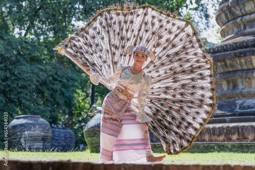 Beautiful Myanmar girl dancing performs imitating bird wings art shown also known as Kingkala Bird Dance. In traditional Dance, National costume of the Tai people, girls wearing bird dresses