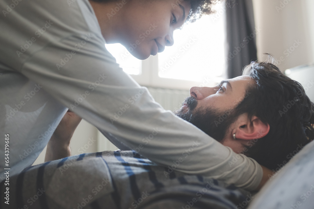 young multiethnic couple indoor hugging bedroom young multiethnic couple indoor hugging bedroom