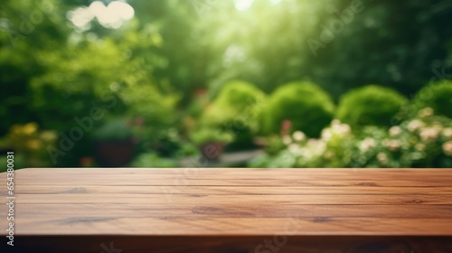 Massive empty wooden outdoor garden table with blurred home green garden view for product placement  frontal view.