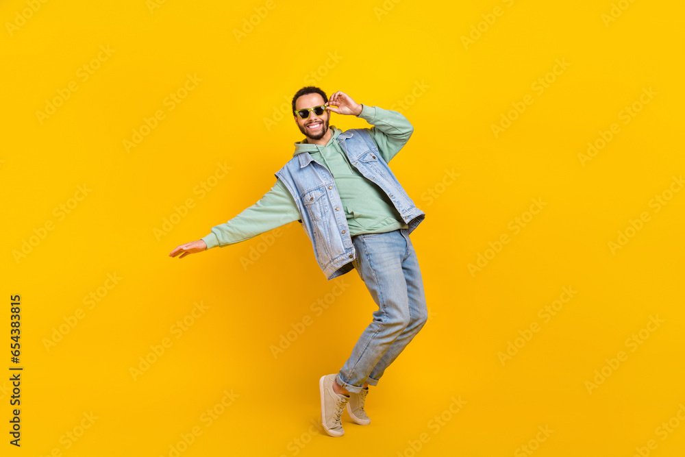 Full body size photo of cool dance youngster boyfriend chill positive careless tiptoes vibe clubbing isolated on yellow color background Full body size photo of cool dance youngster boyfriend chill positive careless tiptoes vibe clubbing isolated on yellow color background