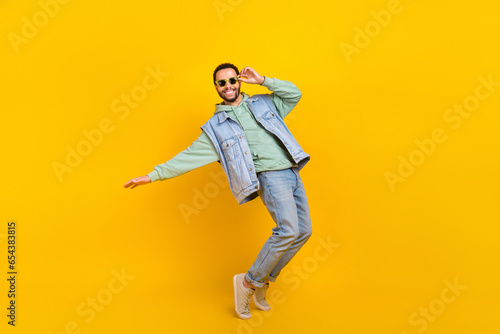 Full body size photo of cool dance youngster boyfriend chill positive careless tiptoes vibe clubbing isolated on yellow color background